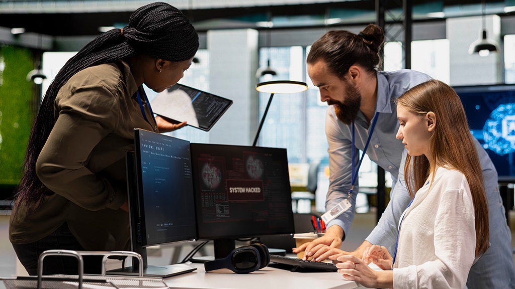 Cybersecurity team collaborating on network security incident response and threat analysis in an office environment